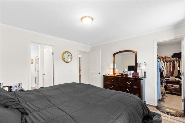 441 Kalynn Cir Unit 26, Fairborn, OH 45324 - bedroom featuring ornamental molding, wood finished floors, a walk in closet, and a closet