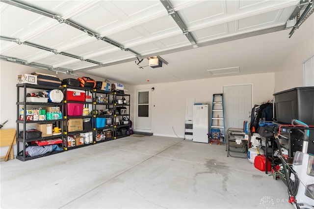 441 Kalynn Cir Unit 26, Fairborn, OH 45324 - garage featuring freestanding refrigerator and a garage door opener