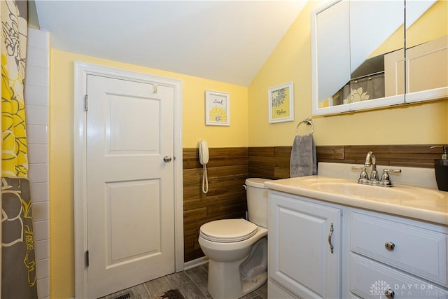 446 Lookout Rdg, Oakwood, OH 45419 - bathroom featuring toilet, vanity, vaulted ceiling, wood finished floors, and wainscoting