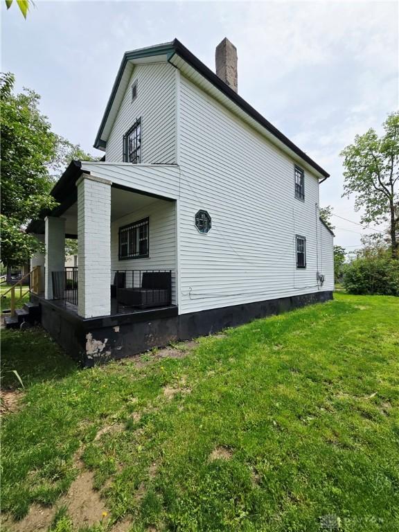40 Gordon Ave, Dayton, OH 45402 - view of home's exterior featuring a porch, a lawn, and a chimney