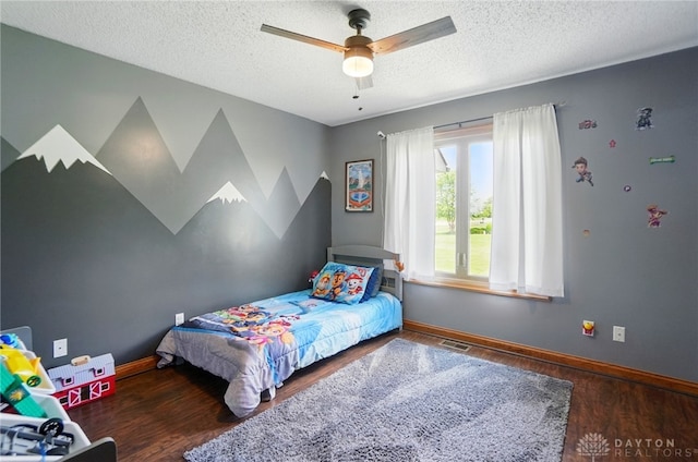 5193 Horseshoe Dr, Lewisburg, OH 45338 - bedroom with wood finished floors, a textured ceiling, baseboards, and a ceiling fan