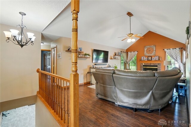 5193 Horseshoe Dr, Lewisburg, OH 45338 - living area featuring lofted ceiling, dark wood finished floors, a chandelier, a fireplace, and a ceiling fan