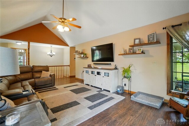 5193 Horseshoe Dr, Lewisburg, OH 45338 - living room featuring dark wood-type flooring, a chandelier, ceiling fan, baseboards, and high vaulted ceiling