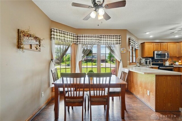 5193 Horseshoe Dr, Lewisburg, OH 45338 - dining area featuring dark wood-type flooring, ceiling fan, baseboards, and a textured ceiling