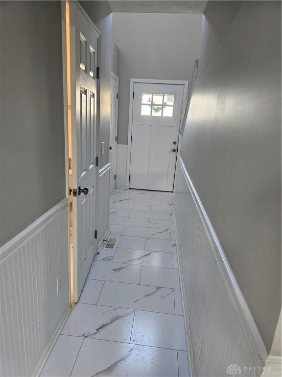 1147 Spegele Ct, Xenia, OH 45385 - doorway with light marble finish flooring and wainscoting