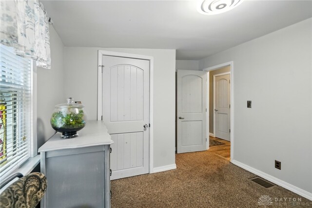 646 Barnhart Rd, Troy, OH 45373 - carpeted bedroom with baseboards and multiple windows