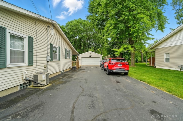 646 Barnhart Rd, Troy, OH 45373 - view of property exterior featuring cooling unit, an outdoor structure, a garage, and a yard
