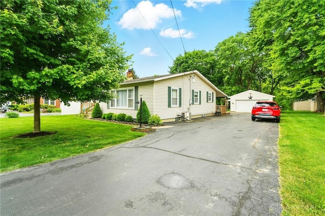 646 Barnhart Rd, Troy, OH 45373 - view of front of house featuring an outdoor structure, a detached garage, a front yard, and a chimney