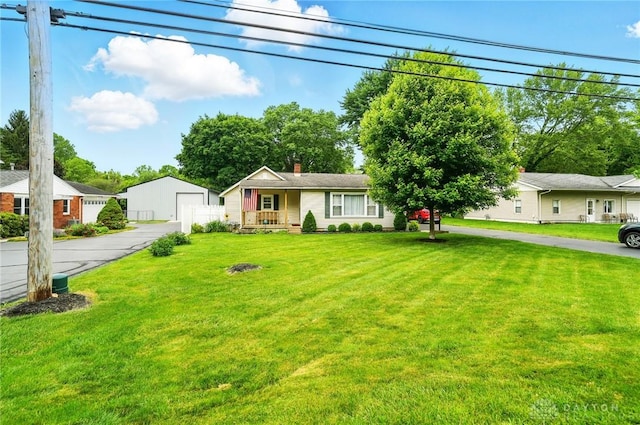 646 Barnhart Rd, Troy, OH 45373 - ranch-style house with a front lawn, covered porch, an outdoor structure, and a chimney