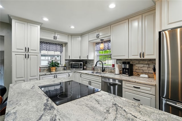 646 Barnhart Rd, Troy, OH 45373 - kitchen with stainless steel appliances, a sink, tasteful backsplash, recessed lighting, and light stone counters