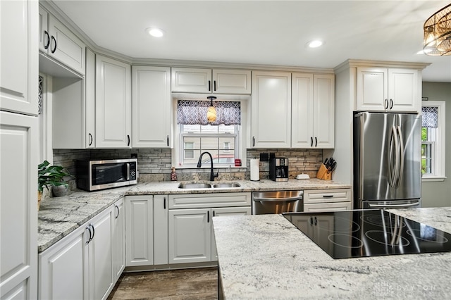 646 Barnhart Rd, Troy, OH 45373 - kitchen featuring appliances with stainless steel finishes, a sink, decorative backsplash, dark wood-type flooring, and recessed lighting