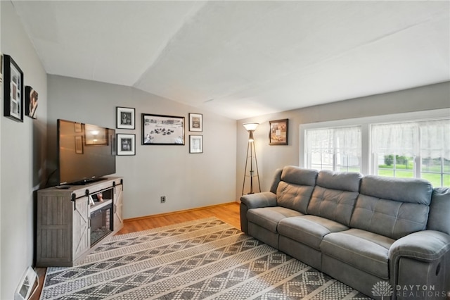 646 Barnhart Rd, Troy, OH 45373 - living room with lofted ceiling, healthy amount of natural light, and wood finished floors