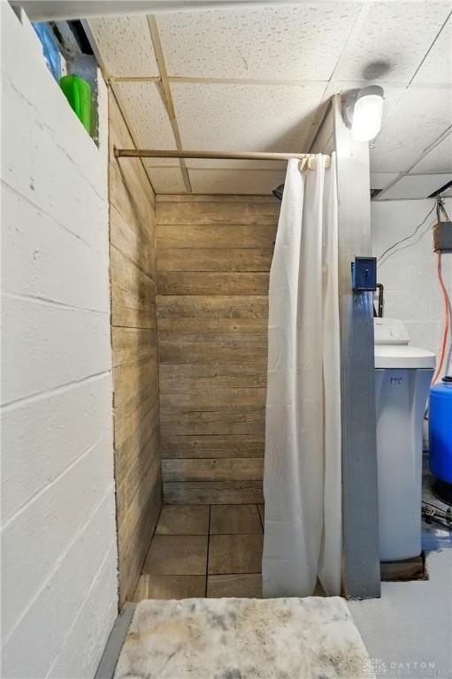 646 Barnhart Rd, Troy, OH 45373 - bathroom featuring wooden walls, a shower with shower curtain, and a paneled ceiling