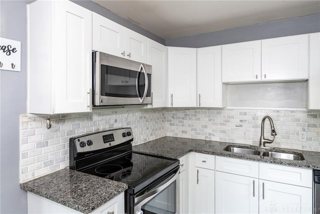 224 Locust Ln, West Milton, OH 45383 - kitchen featuring appliances with stainless steel finishes, a sink, decorative backsplash, and white cabinets
