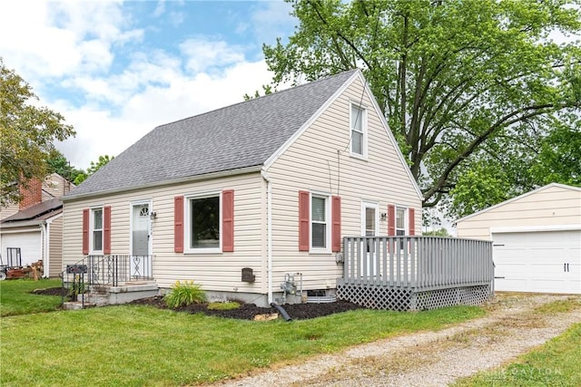 224 Locust Ln, West Milton, OH 45383 - cape cod house featuring a shingled roof, an outbuilding, a front lawn, a detached garage, and a wooden deck