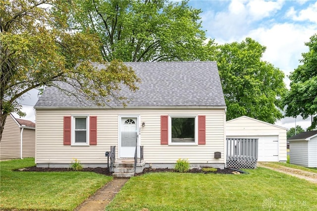 224 Locust Ln, West Milton, OH 45383 - cape cod house featuring a front yard, a shingled roof, and a detached garage