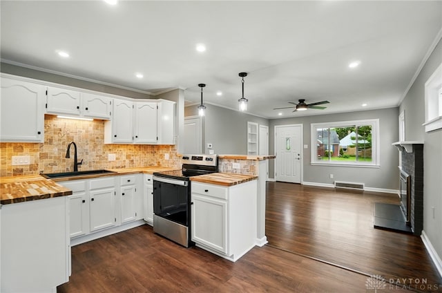 1725 Humphrey Ave, Dayton, OH 45410 - kitchen featuring butcher block counters, stainless steel electric range oven, a peninsula, ceiling fan, and recessed lighting