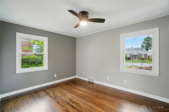 1725 Humphrey Ave, Dayton, OH 45410 - spare room with healthy amount of natural light, ornamental molding, dark wood-style floors, and ceiling fan