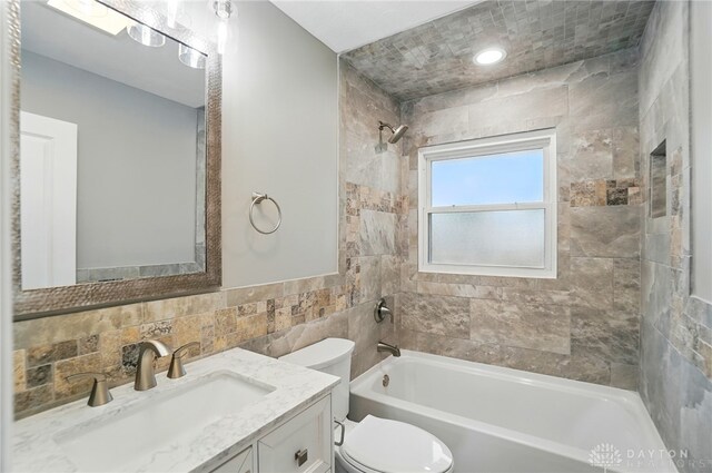 1725 Humphrey Ave, Dayton, OH 45410 - full bath with tile walls, vanity, and shower / bath combination