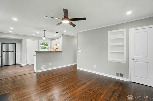 1725 Humphrey Ave, Dayton, OH 45410 - unfurnished living room with recessed lighting, a ceiling fan, crown molding, dark wood-type flooring, and built in shelves