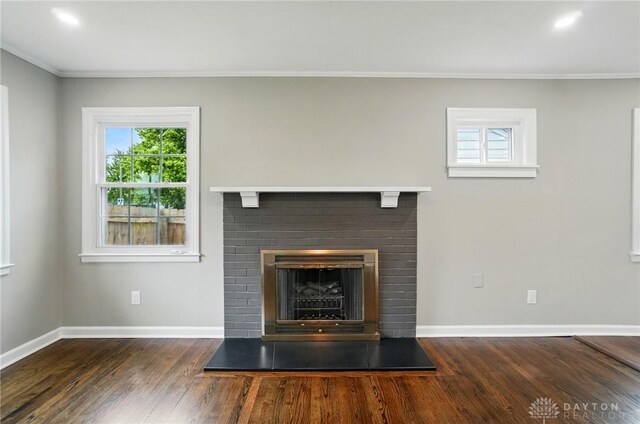 1725 Humphrey Ave, Dayton, OH 45410 - unfurnished living room featuring a brick fireplace, crown molding, wood finished floors, and recessed lighting