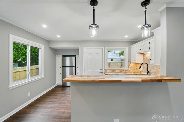 1725 Humphrey Ave, Dayton, OH 45410 - kitchen featuring wooden counters, plenty of natural light, ornamental molding, freestanding refrigerator, and recessed lighting