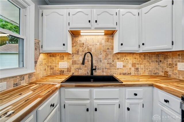 1725 Humphrey Ave, Dayton, OH 45410 - kitchen with butcher block countertops, white cabinets, and backsplash