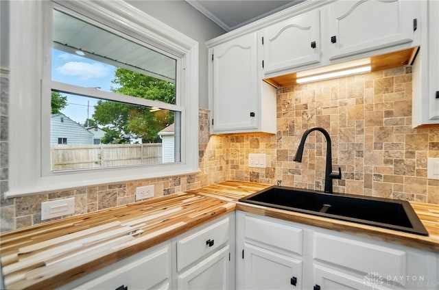 1725 Humphrey Ave, Dayton, OH 45410 - kitchen featuring wooden counters, tasteful backsplash, white cabinets, and crown molding