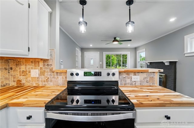 1725 Humphrey Ave, Dayton, OH 45410 - kitchen featuring stainless steel range with electric cooktop, butcher block countertops, crown molding, decorative backsplash, and white cabinetry