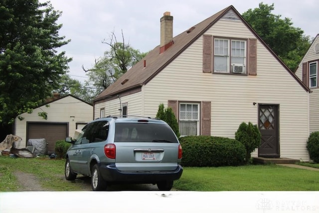 313 Archer Dr, Fairborn, OH 45324 - view of front facade with a chimney, an outbuilding, a front lawn, and a garage