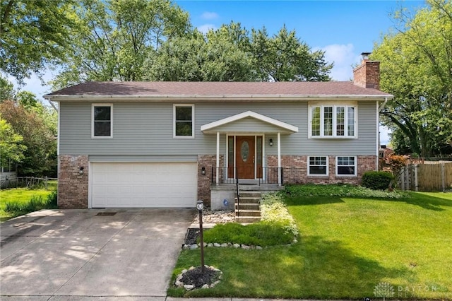 4278 Crownwood Ave, Dayton, OH 45415 - split foyer home featuring brick siding, a garage, a chimney, and concrete driveway
