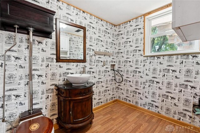 4278 Crownwood Ave, Dayton, OH 45415 - bathroom with wood finished floors, vanity, and wallpapered walls