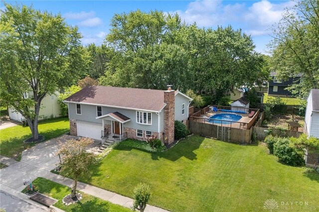 4278 Crownwood Ave, Dayton, OH 45415 - split foyer home featuring a chimney, a garage, and driveway