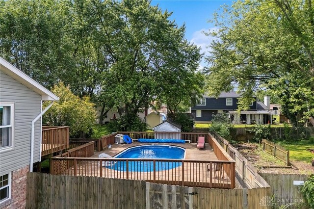 4278 Crownwood Ave, Dayton, OH 45415 - view of pool with a wooden deck, a fenced backyard, and a shed