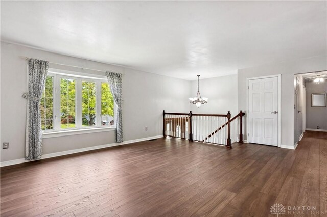 4278 Crownwood Ave, Dayton, OH 45415 - empty room with a chandelier and dark wood-style floors