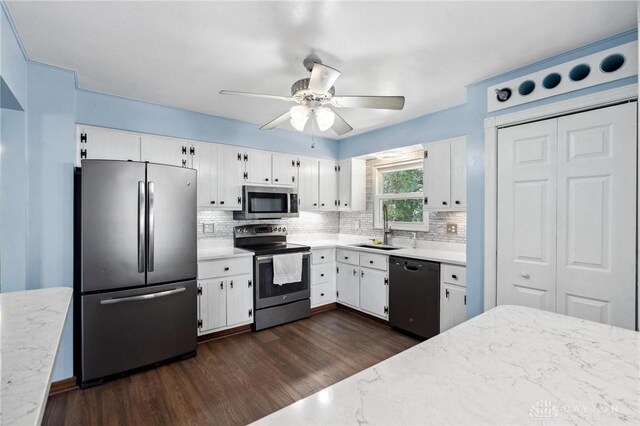 4278 Crownwood Ave, Dayton, OH 45415 - kitchen with appliances with stainless steel finishes, backsplash, white cabinetry, a ceiling fan, and dark wood-style floors