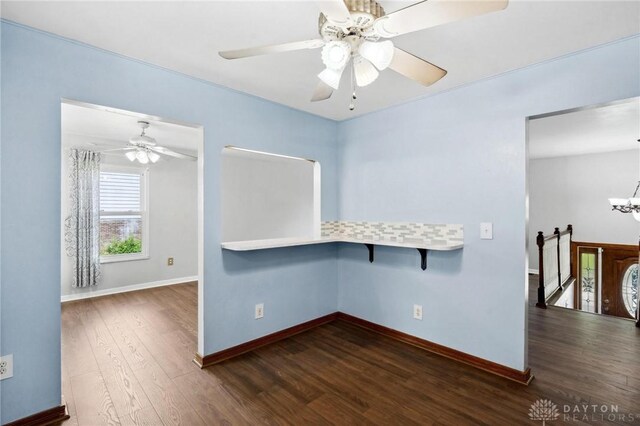 4278 Crownwood Ave, Dayton, OH 45415 - spare room featuring dark wood-style flooring, a ceiling fan, and a chandelier
