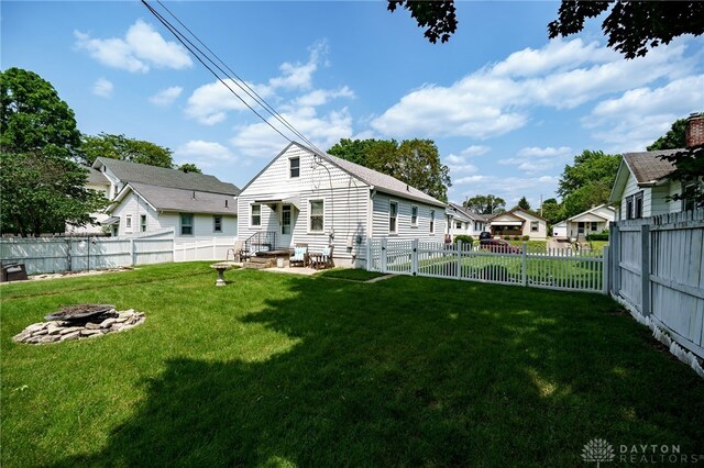 2231 King Ave, Dayton, OH 45420 - rear view of property featuring an outdoor fire pit, a fenced backyard, a residential view, and entry steps