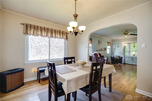 2231 King Ave, Dayton, OH 45420 - dining area with arched walkways, light wood-style flooring, ornamental molding, and ceiling fan