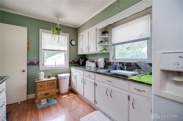 2231 King Ave, Dayton, OH 45420 - kitchen with dark countertops, healthy amount of natural light, white cabinets, and ornamental molding