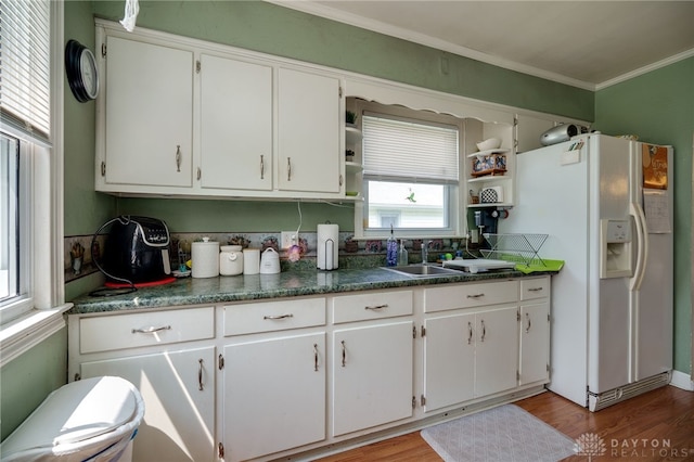 2231 King Ave, Dayton, OH 45420 - kitchen with white fridge with ice dispenser, open shelves, crown molding, white cabinets, and light wood-style floors