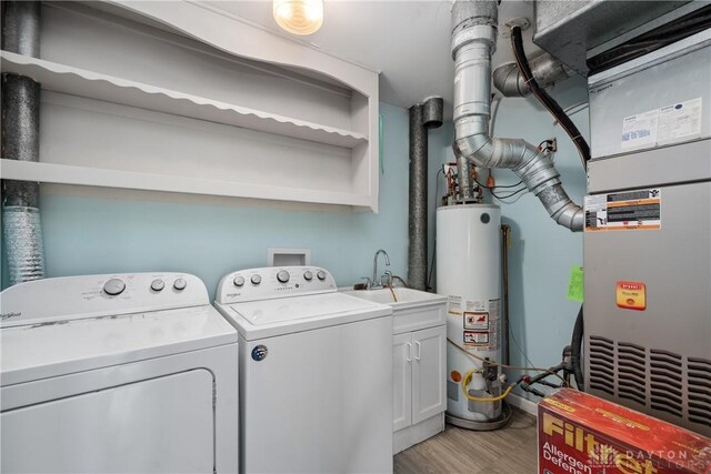 2378 E Rahn Rd, Kettering, OH 45440 - laundry room with gas water heater, independent washer and dryer, cabinet space, light wood-style flooring, and heating unit