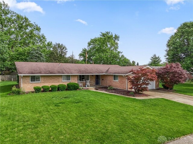 2378 E Rahn Rd, Kettering, OH 45440 - ranch-style house featuring brick siding, driveway, a front yard, and a garage
