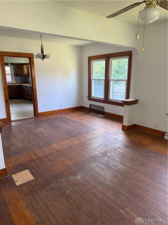 114 N Clayton Rd, New Lebanon, OH 45345 - unfurnished room with hardwood / wood-style flooring, a chandelier, and ceiling fan