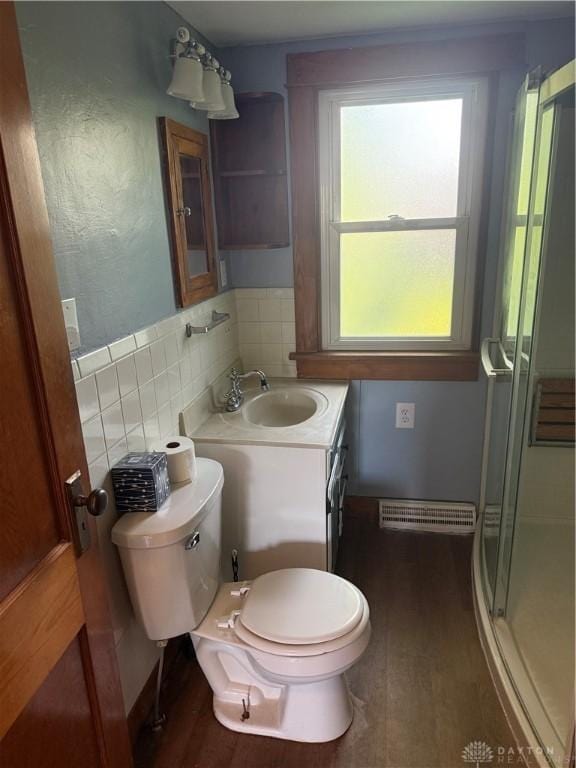 114 N Clayton Rd, New Lebanon, OH 45345 - full bath featuring wood finished floors, a stall shower, vanity, and tasteful backsplash