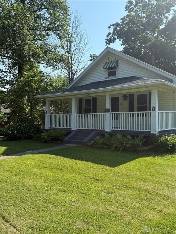 114 N Clayton Rd, New Lebanon, OH 45345 - view of front of home featuring a porch and a front lawn