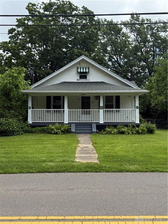 114 N Clayton Rd, New Lebanon, OH 45345 - view of front of house with a porch and a front lawn