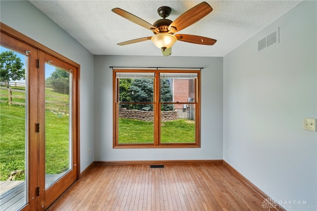 617 Orient Way, Hamilton, OH 45013 - empty room with light wood-style floors, a textured ceiling, and ceiling fan