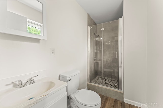 1927 Vermont Dr, Xenia, OH 45385 - full bathroom featuring a stall shower, wood finished floors, and vanity