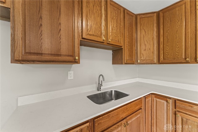 1927 Vermont Dr, Xenia, OH 45385 - kitchen featuring light countertops and brown cabinetry